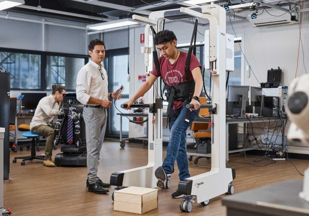 UQ researchers test a piece of walking equipment in a robotics laboratory