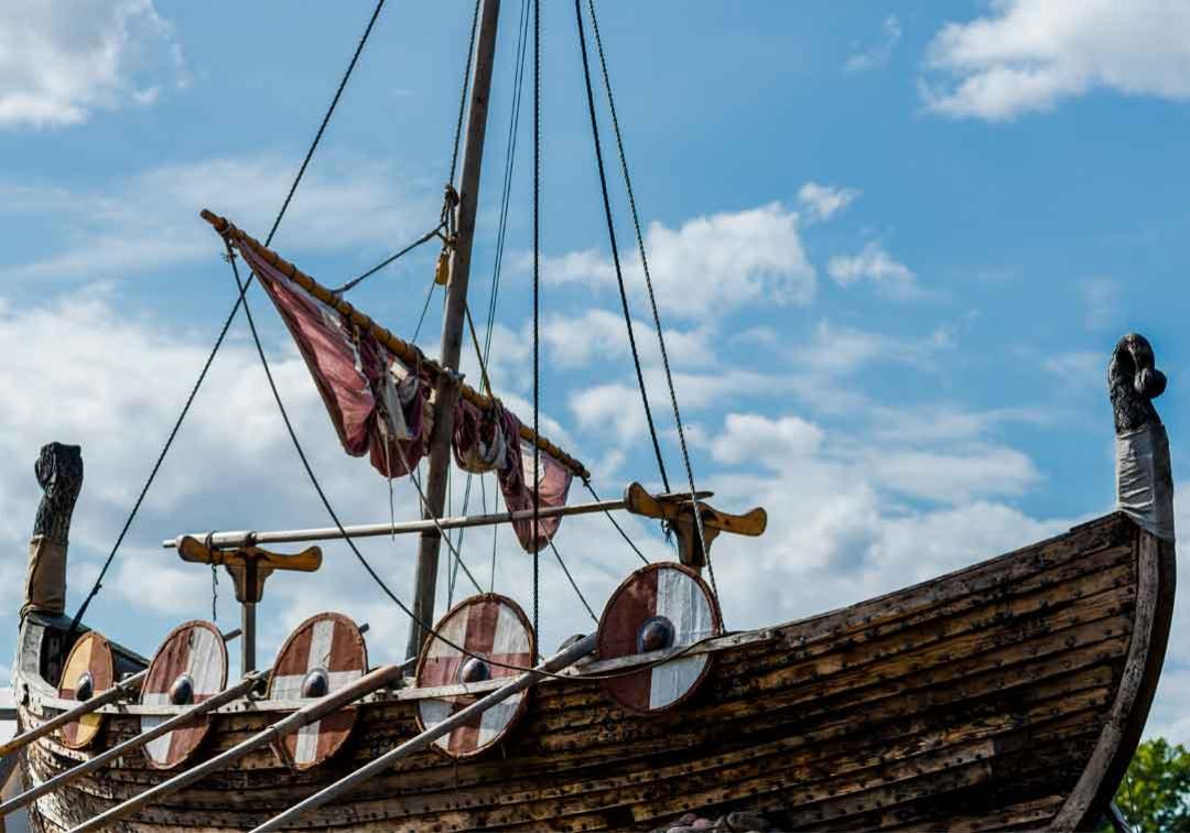 A Viking longship with shields and oars off the side of the boat