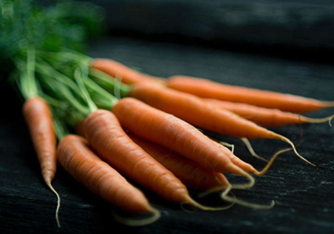 A bunch of carrots that are not uniform in size.