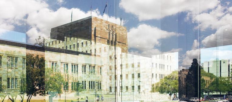 Reflection of UQ's Forgan Smith building in glass windows.