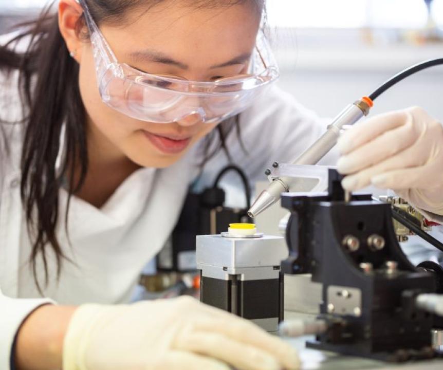 Woman works in lab on medical device