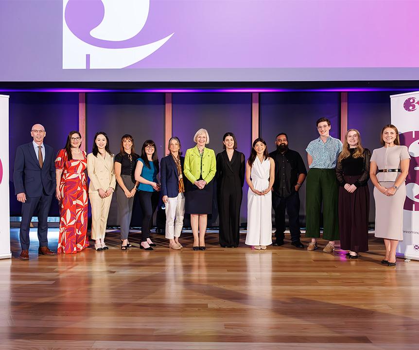 A group of people standing on a stage.