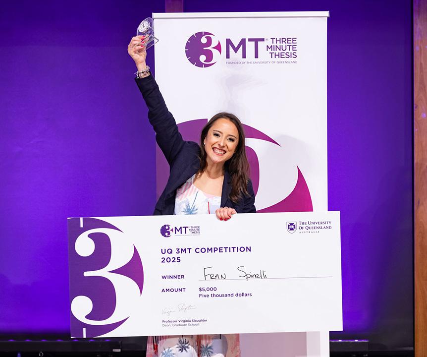 The winner of the Three Minute Thesis standing on stage.
