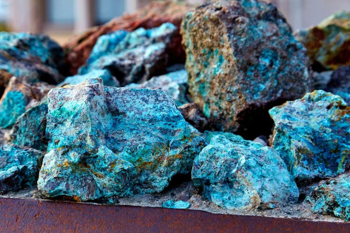 Close up of a pile of blue-gold copper ore rocks.