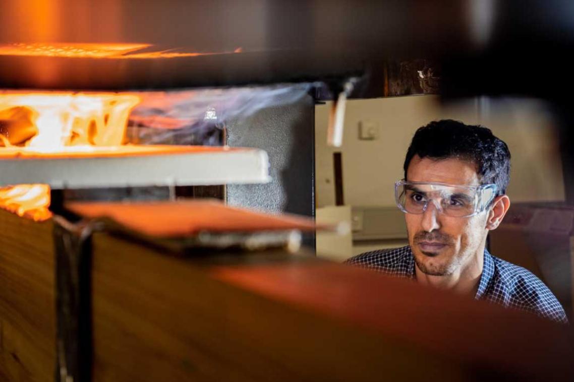 UQ expert surveys a flaming machine in one of the advanced manufacturing labs.