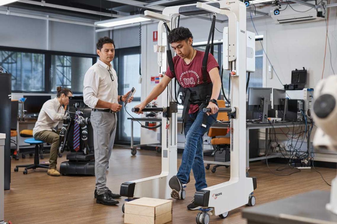 UQ researchers test a piece of walking equipment in a robotics laboratory