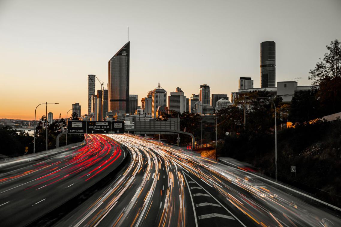 Traffic moving past Brisbane city at sunset