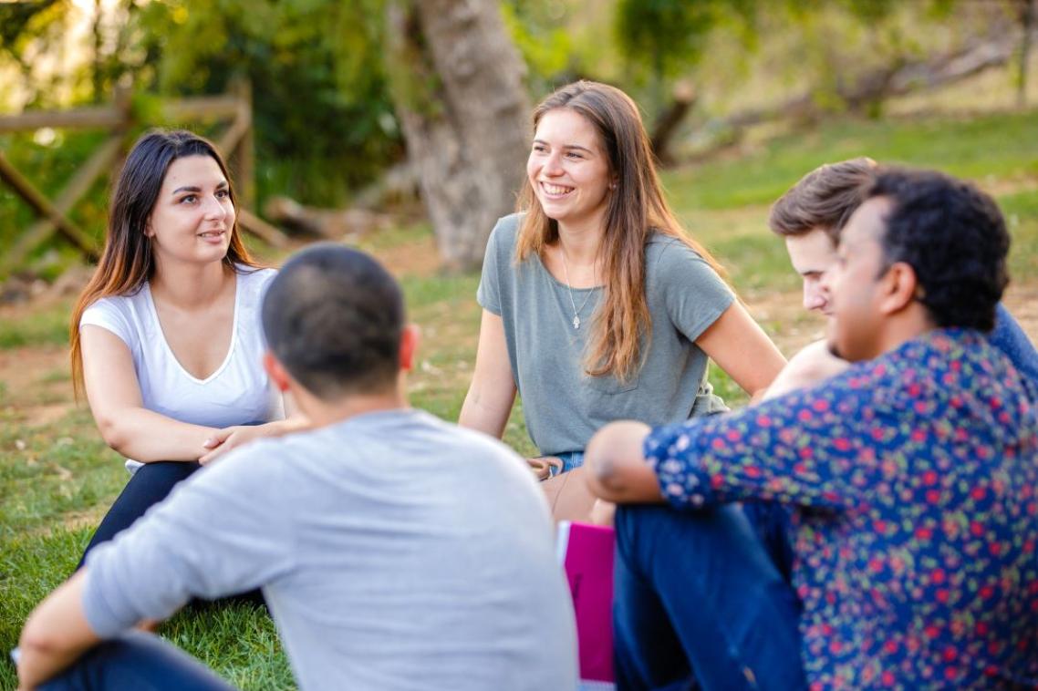 Students relaxing outside accommodation