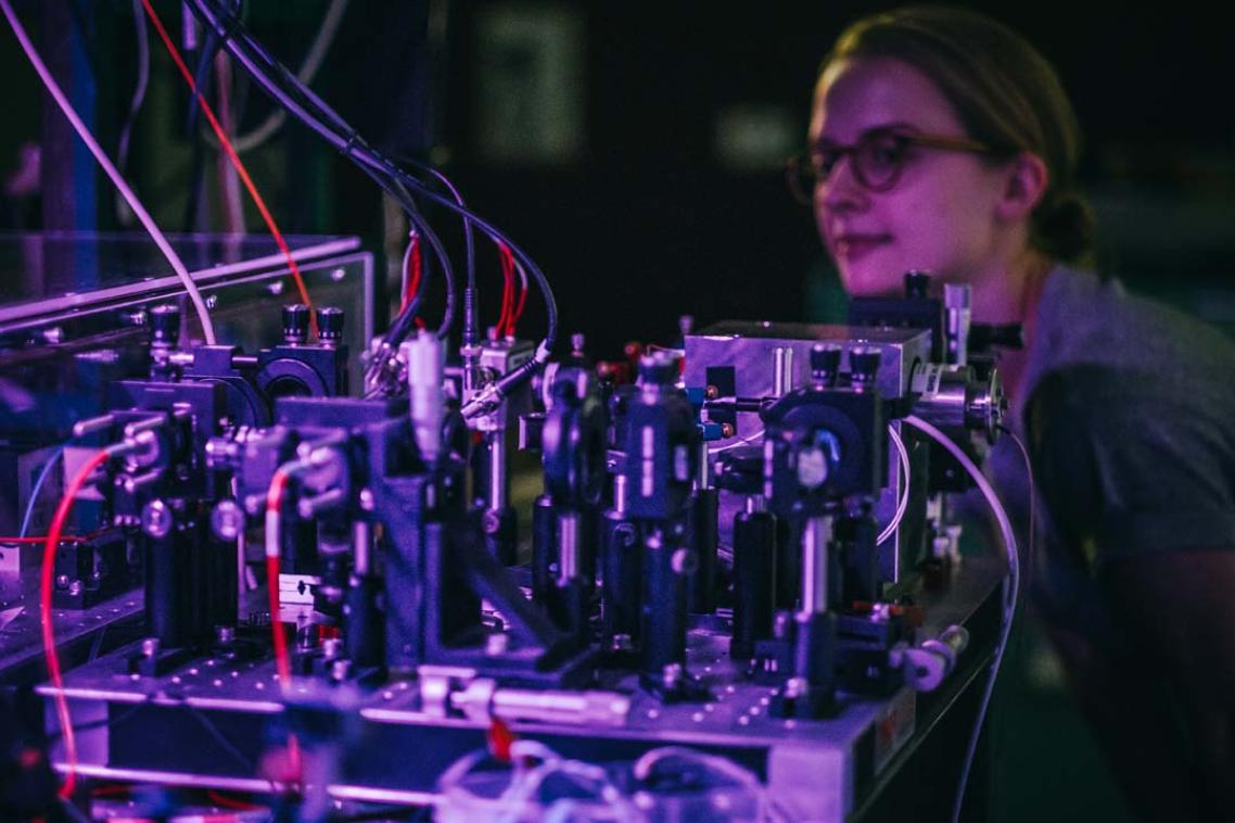 UQ researcher examines a series of technical looking tubes and wires